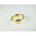 An 18ct yellow gold wedding band