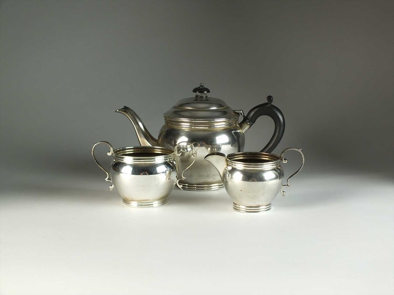 A three piece silver tea service