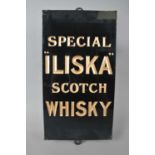 An original slate-backed glass advertising sign for 'Special "Iliska" Scotch Whisky'