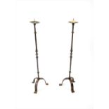 A tall pair of 18th century and later wrought iron floor-standing pricket stands,