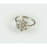A platinum seven stone diamond floral cluster ring