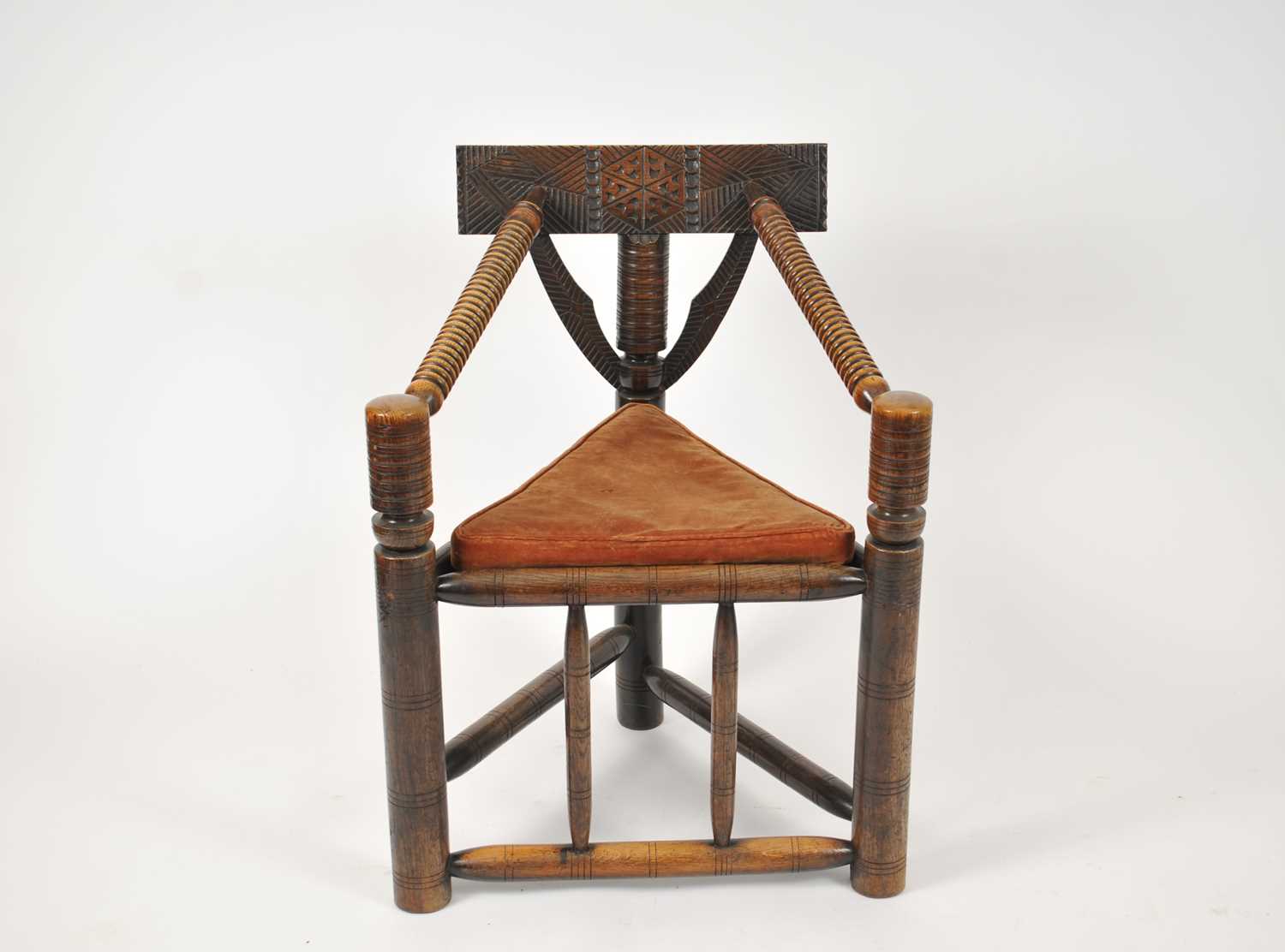 A Victorian carved oak turners chair, with a chip carved hexagonal motif on the top rail and ring