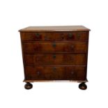 A Queen Anne walnut chest of two short and three long graduated drawers, of good colour, inlaid with