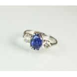 A three stone sapphire and diamond ring