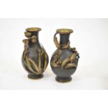 A pair of Meiji period bronze vases, of baluster shape, one decorated in relief with irises and