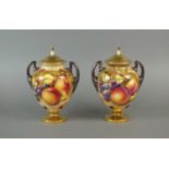 A pair of Royal Worcester twin-handled vases and covers