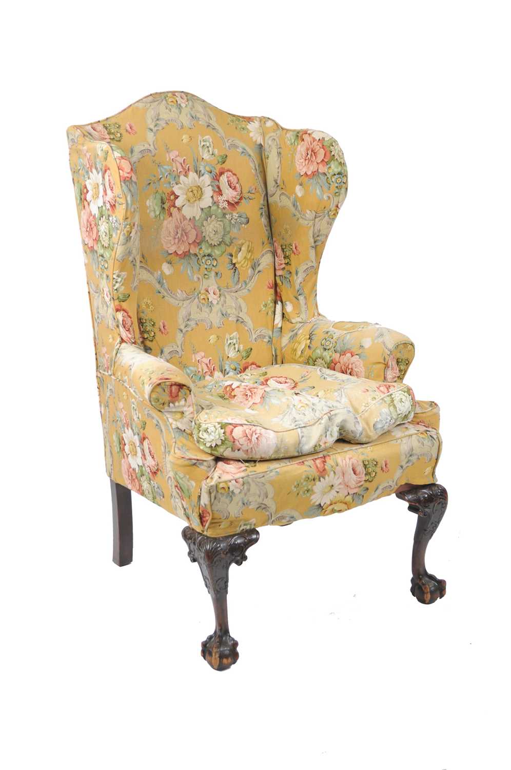 An early 20th century, George II style, wing armchair of generous proportions, the cabriole legs