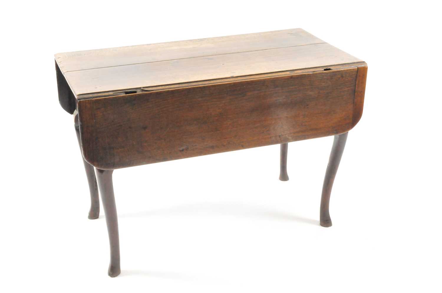 An early-mid 18th century oak single gateleg table, the rectangular top above arc d'arbelette shaped