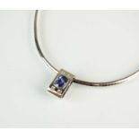 A tanzanite and diamond pendant on chain