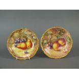 A pair of Royal Worcester fruit-decorated side plates