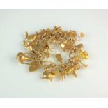 A 9ct gold hollow curb link bracelet with attached 9ct gold and yellow metal charms