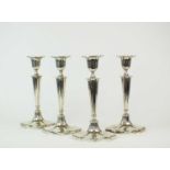 A set of four silver mounted candlesticks