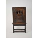 A good 17th century style rectangular oak mural cupboard with moulded rails and stiles and a central