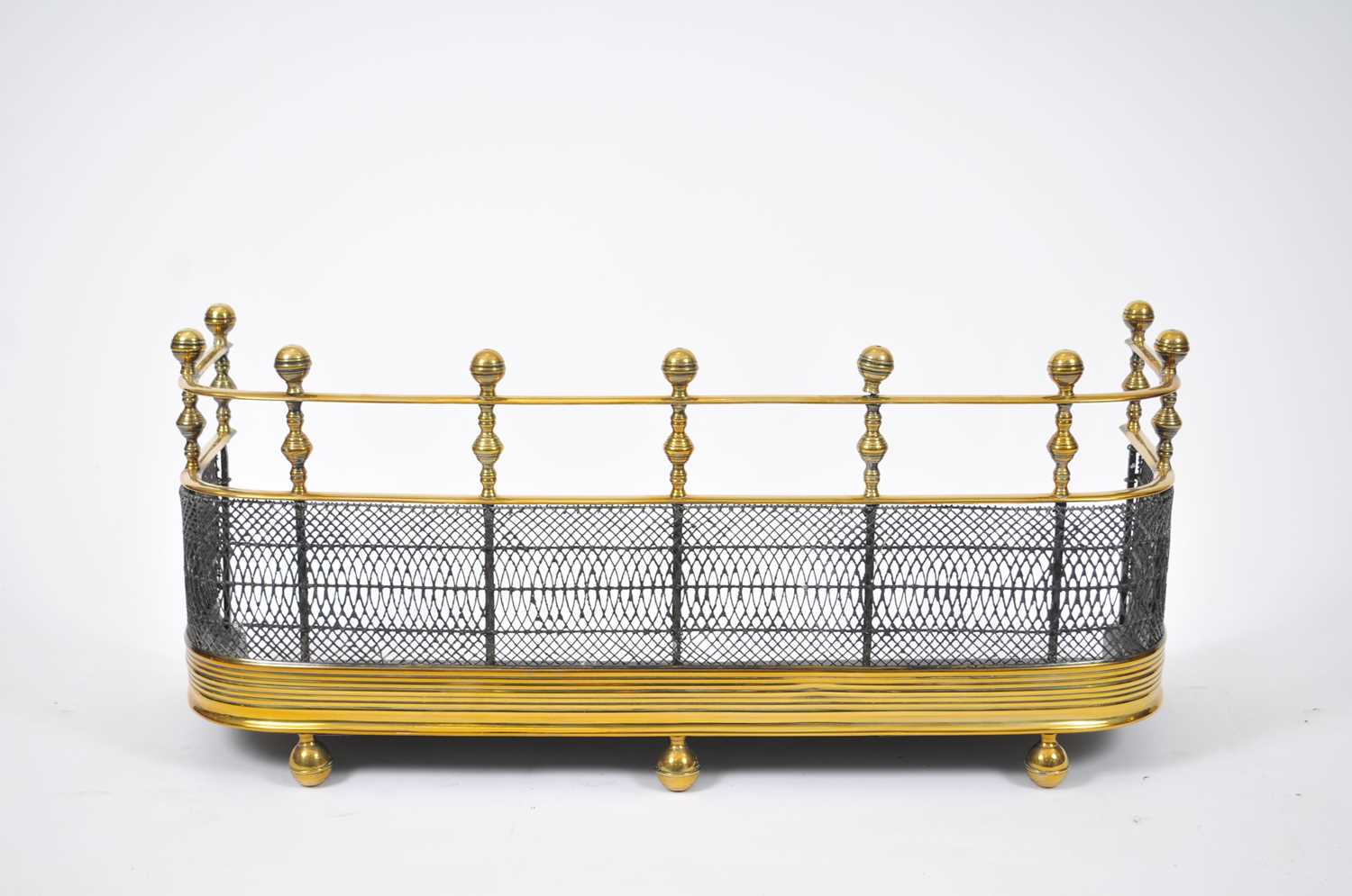 A 19th century brass fireguard, with a balustered upper section and mesh below, 79 x 27 x 37cm high