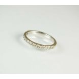 A 9ct white gold diamond set half hoop eternity ring