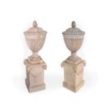 A pair of Coade urns, with bud form finials and fluted sides, bases impressed 'Coade Lambeth