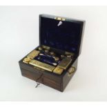 A William IV Cormandel cased silver gilt travelling set