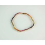 A 9ct gold multi-coloured 'rainbow' sapphire bracelet