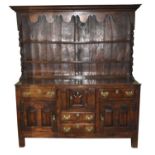 An early-mid 18th century oak dresser, North Wales, the rack with a cavetto cornice above an