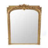 A Victorian gilt gesso over mantel mirror of depressed arched form, the cresting with a central