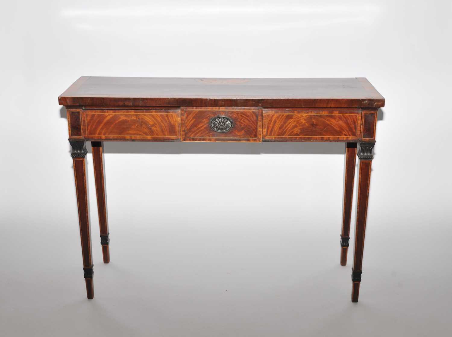 A George III mahogany and satinwood crossbanded serving table, the rectangular top inlaid with a