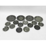 A collection of seven 19th century pewter chargers, approximately 38cm diameter and 21 plates,