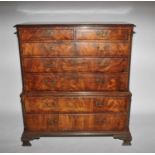 A good mid-18th century figured mahogany veneered chest on chest, with blind fretwork canted