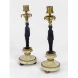 A pair of Regency bronze, gilt bronze and marble candle sticks in the form of classical figures with
