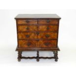 An early 18th century walnut veneered chest, of two short and three long graduated drawers,