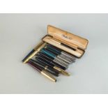 A collection of fountain pens, pens and pencils