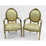 A pair of Louis XV style carved giltwood open armchairs