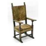 A 19th century, 17th century style, Iberian elbow chair, with a painted hide and studded back and