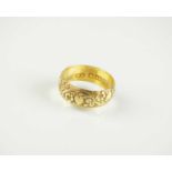 An 18ct gold decorative wedding band