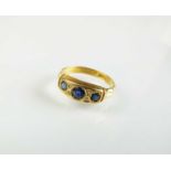 An Edwardian 18ct gold seven stone sapphire and diamond ring