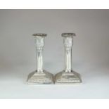A pair of Victorian silver mounted candlesticks