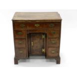 A George II walnut veneered dressing chest, the rectangular top 1/4 veneered and inlaid with feather