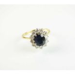 An 18ct gold sapphire and diamond oval cluster ring