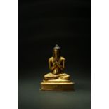 A good Tibetan gilt copper alloy figure of Shakyamuni Buddha, 15th century