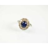 A sapphire and diamond oval cluster ring