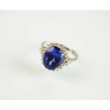 An 18ct white gold tanzanite and diamond cluster ring