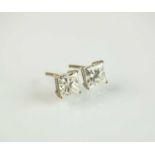 A pair of Princess cut diamond stud earrings