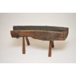 A large and heavy rustic French oak manger, of simple hewn form, with iron mounts, raised on
