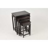 A graduating nest of four early 20th century Chinese hardwood occasional tables, the largest
