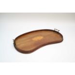 An Edwardian kidney shaped mahogany drinks tray, with central shell inlay flanked by brass
