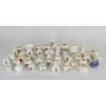 An assorted collection of crested ware comprising examples by Arcadian, Carlton, Goss and Shelley,