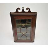 A 19th century glazed-front oak wall-hanging corner cupboard, with a painted shelved interior, 117 x