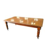 An early 20th century heavy pale oak extending dining table, the stepped top with rounded corners,