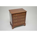 A good quality mahogany reproduction chest of four graduated long drawers, with polished brass