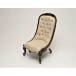 A Victorian mahogany framed spoon back chair, upholstered in a cream material, with buttoned back,
