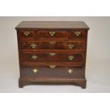A 19th century mahogany chest of drawers, the over-hanging top with strung inlaid borders above a